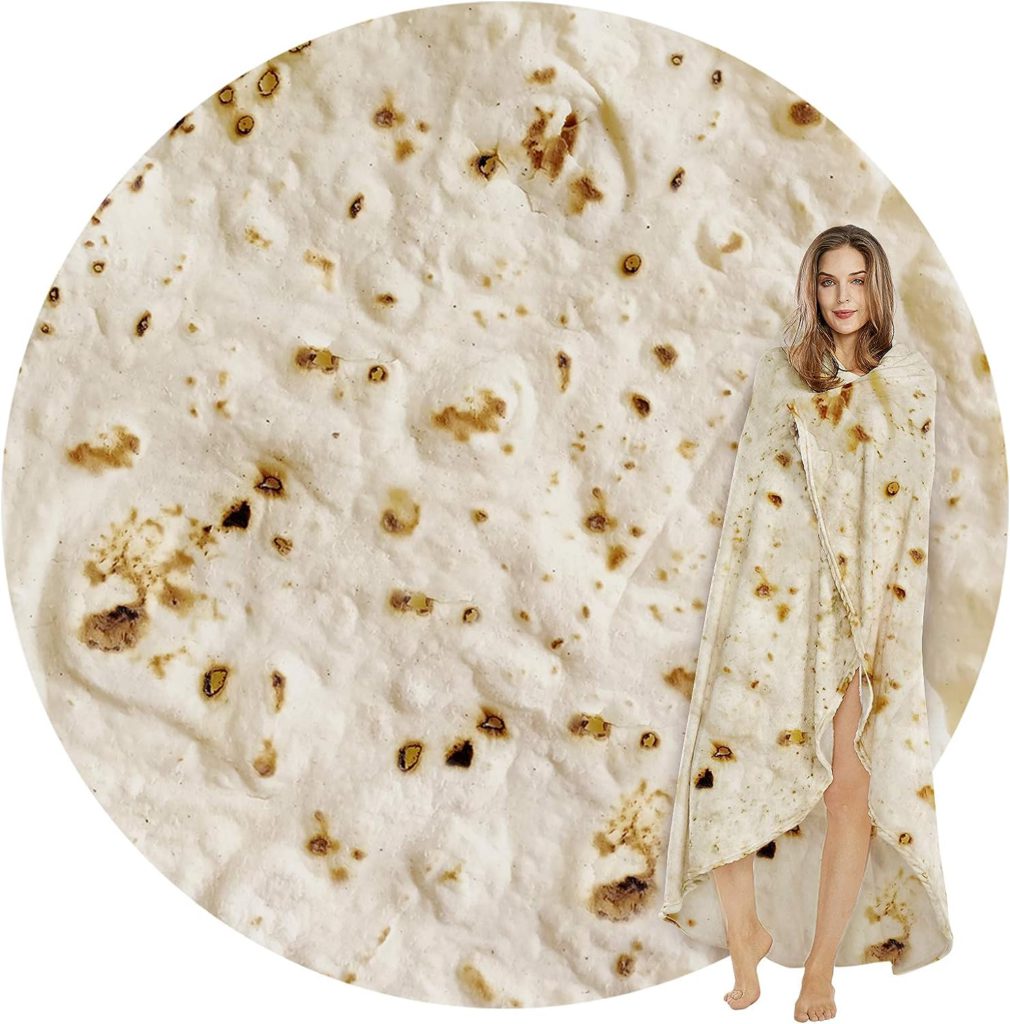 The image shows a roung tortilla, life like in its image with tan and brown texture. Next to the image is a woman wrapped in a tortilla blanket.