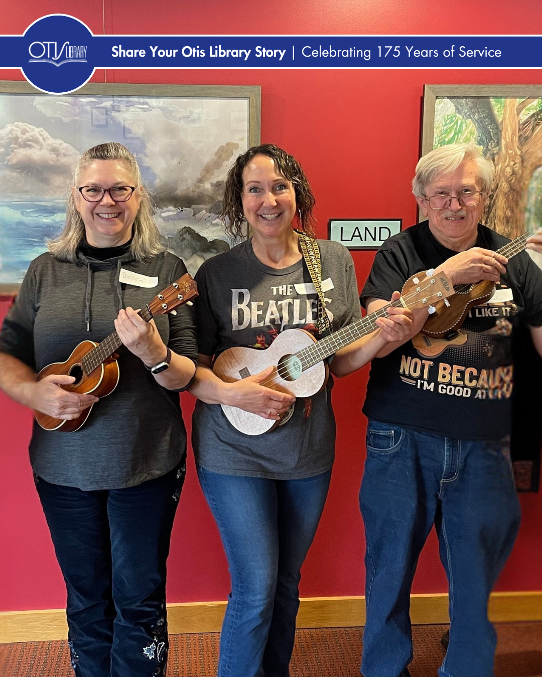 Gina stands in the center with two other people. They are all holding ukuleles and smiling at the camera.